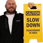 SmartSign - SF-0292-FB-25x12 Caution - Slow Down, Pedestrians In Area Folding Floor Sign By | 25" x 12" Plastic Black on Yellow